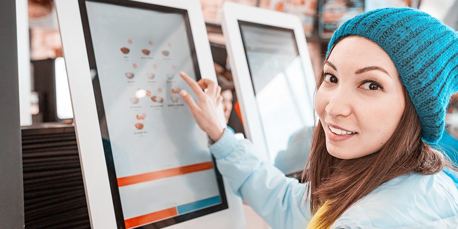 customer ordering at a QSR kiosk