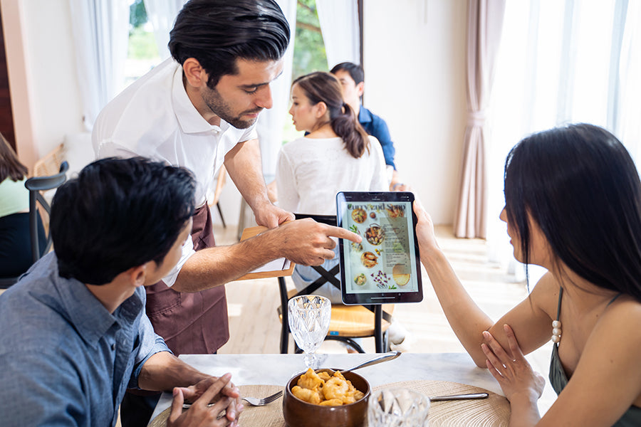 waiter taking an order with a tablet