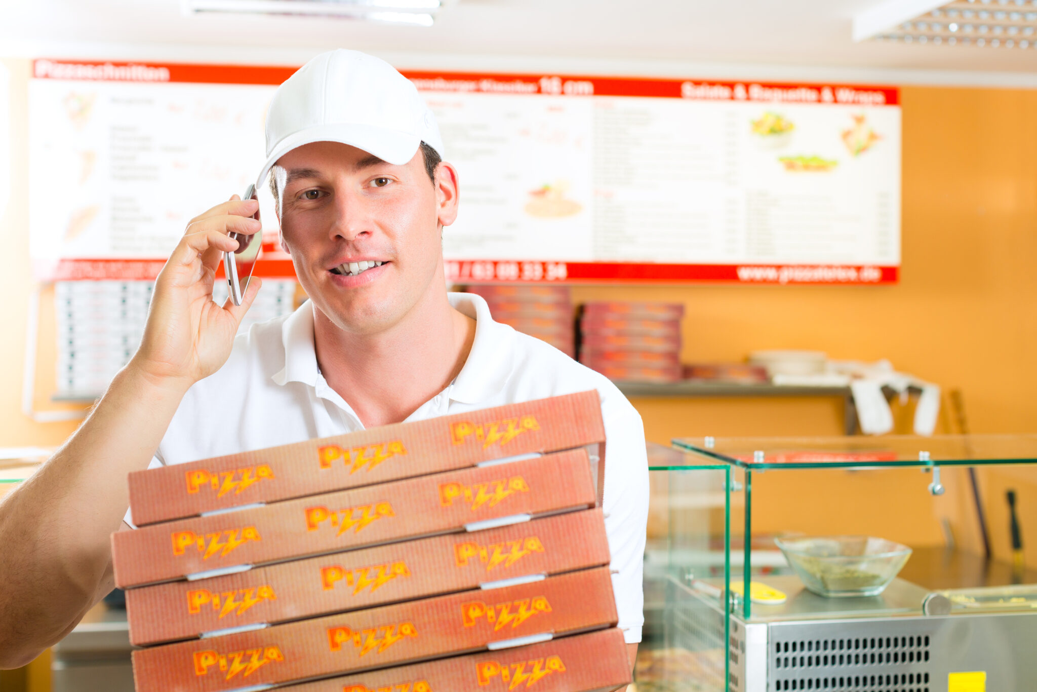 Man holding several pizza boxes in hand and asking you to order Pizza pos