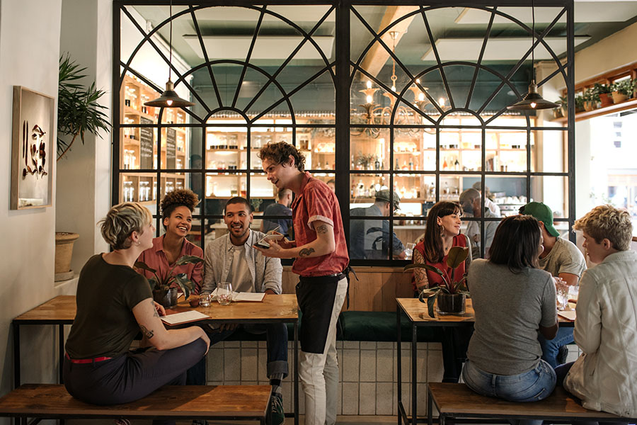 Smiling Young Waiter Taking Orders From A Diverse Group Of Custo Everything You Need to Know about Restaurant POS