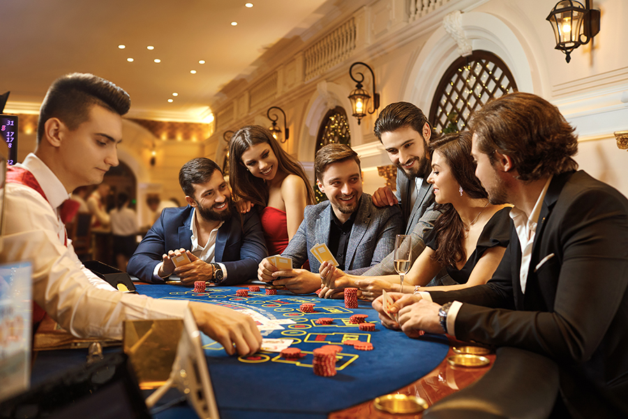 A group of people playing gambling in a casino.